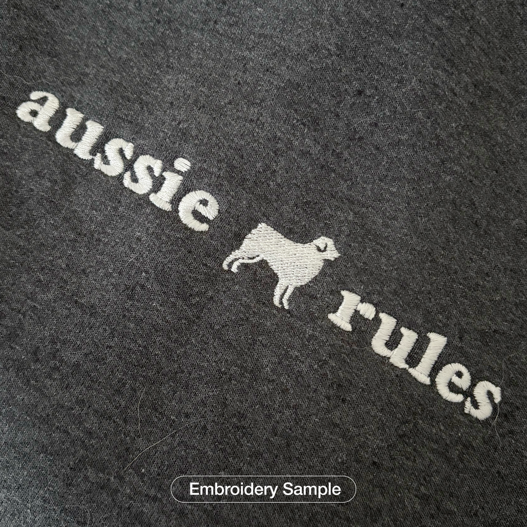 Close-up of embroidered breed silhouette stitching on a Super Unleashed sweatshirt